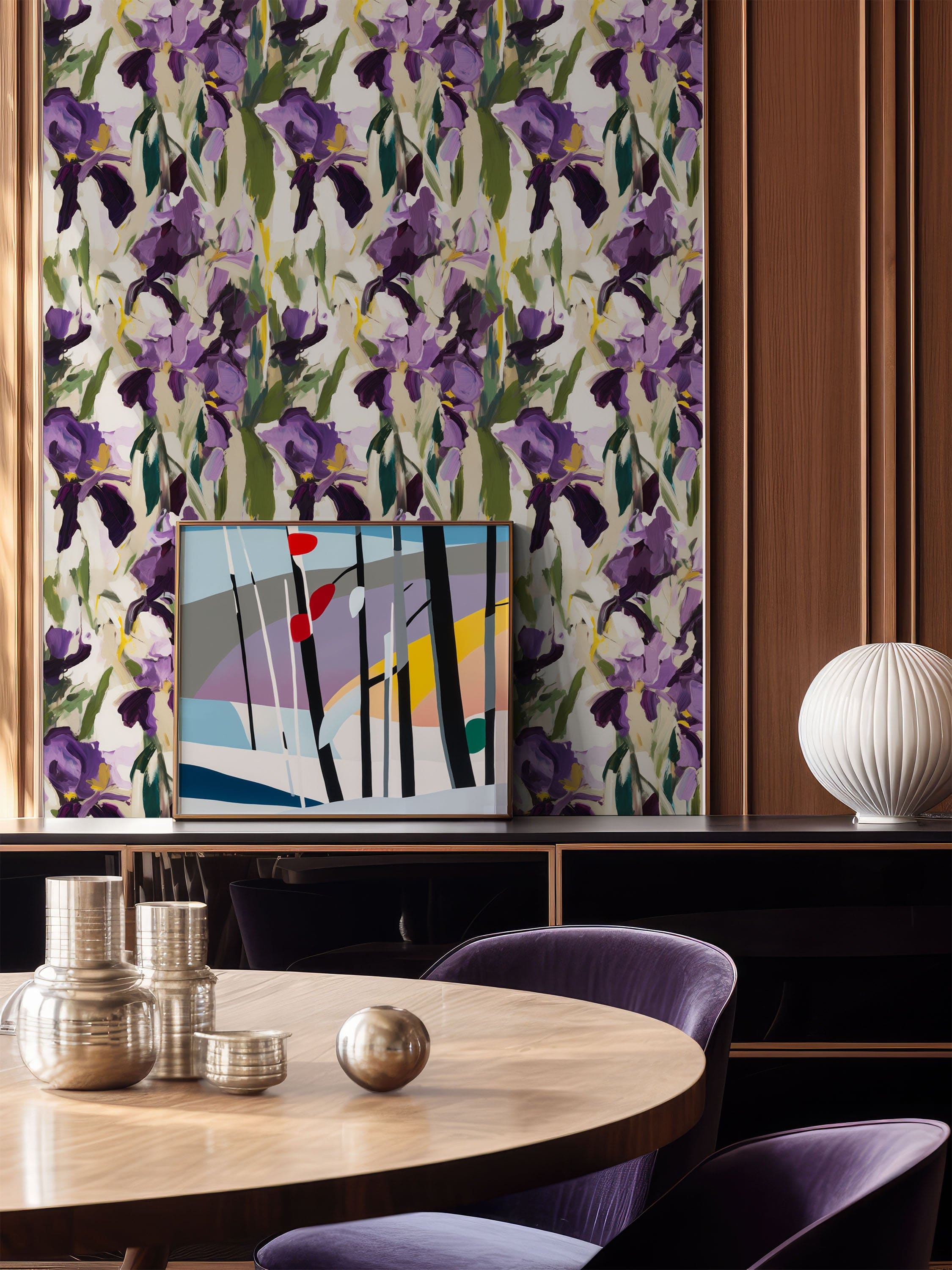 Painterly iris floral wallpaper in purple and green tones, styled in a contemporary dining room with wooden furniture, abstract artwork, and sculptural lighting.