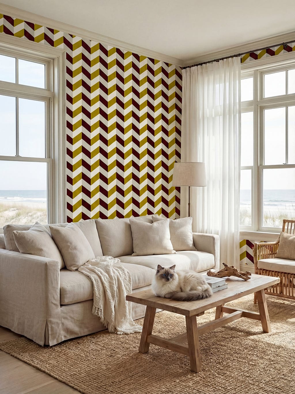 Living room with chevron patterned wall, sofa, coffee table, and cat.
