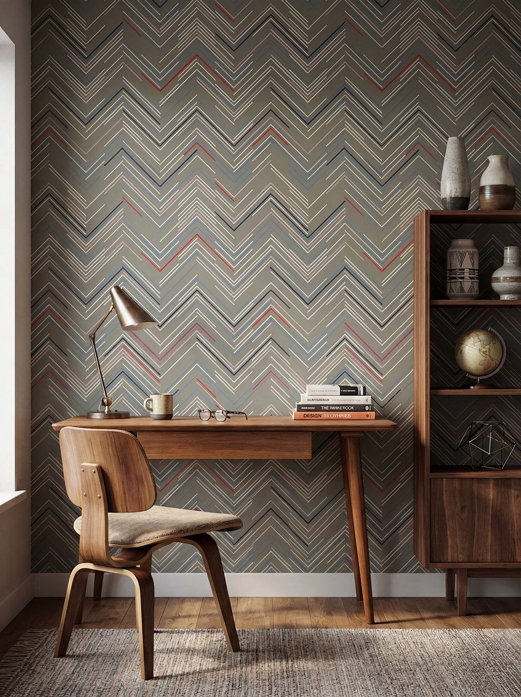 Room interior with a wooden desk, chair, and shelves against a chevron-patterned wall.