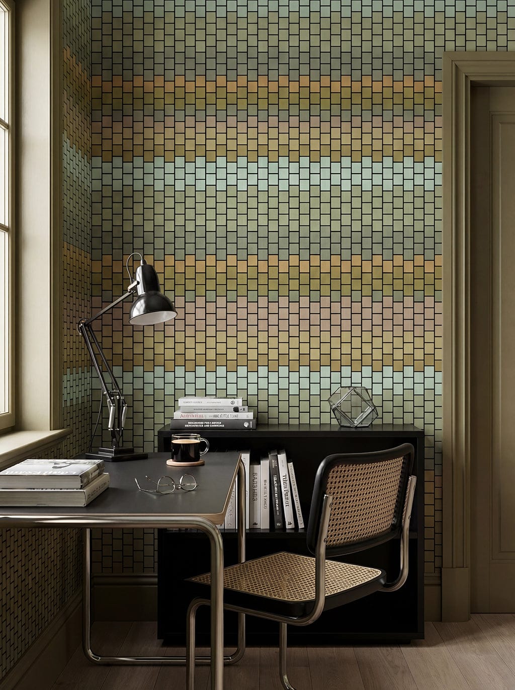 Modern office setup with a desk, chair, and lamp against a decorative wall.