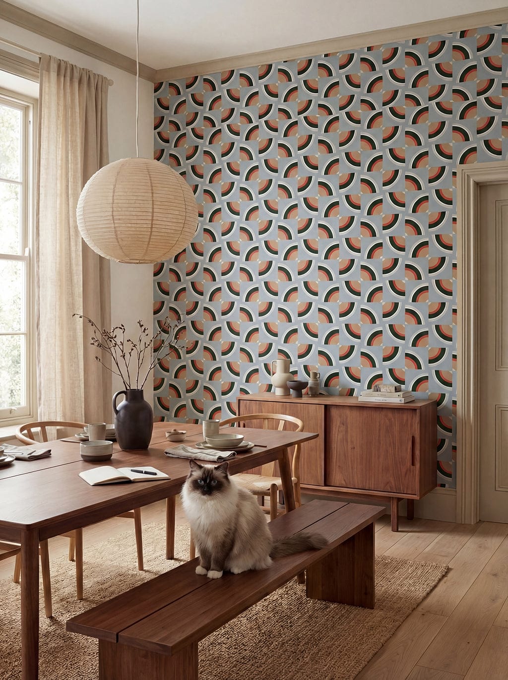 Dining room with wooden furniture, patterned wall, and a cat on a bench.
