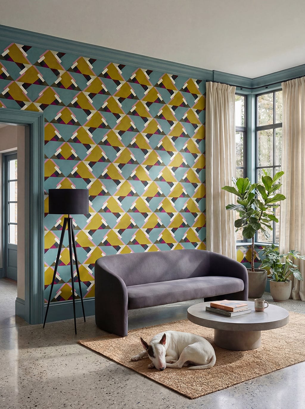Living room with geometric patterned wall, gray sofa, and decorative elements.