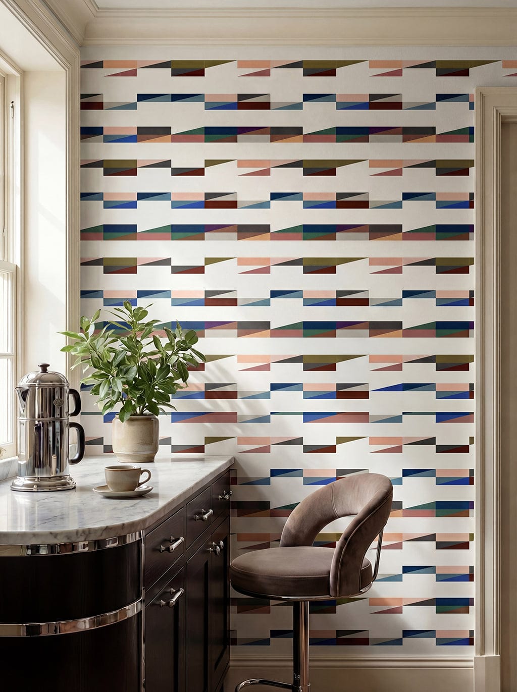 Modern kitchen with geometric patterned wallpaper, marble countertop, and bar stool.