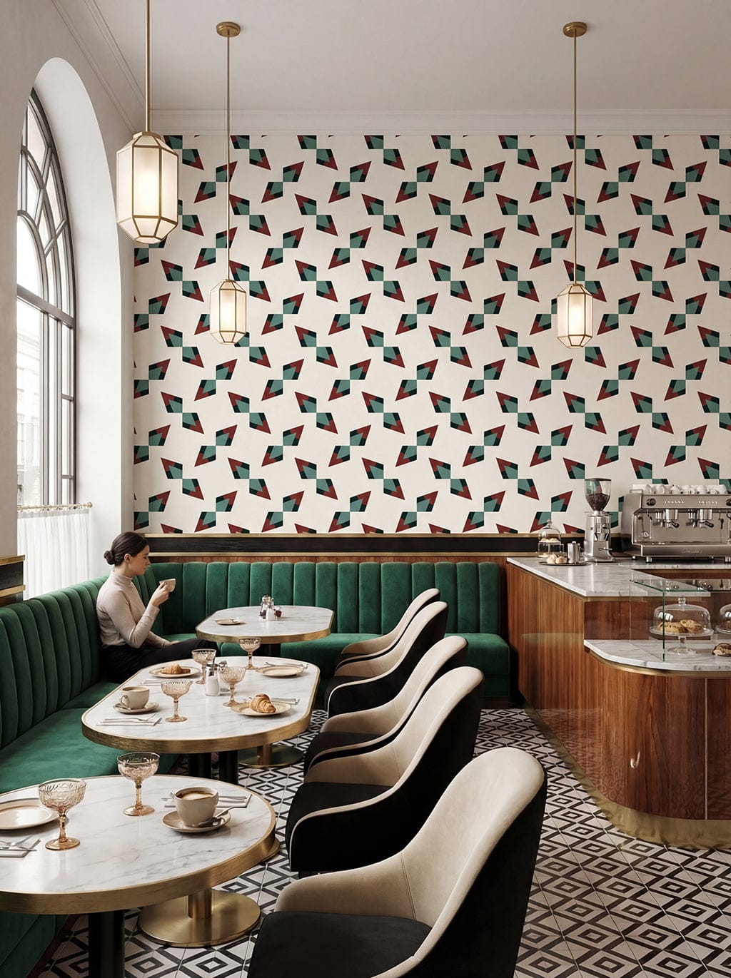Modern restaurant interior with geometric patterned wall, green booths, and patterned floor.